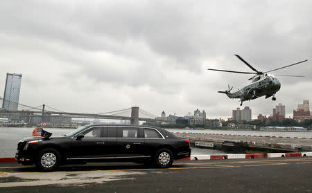 FILE PHOTO: The Marine One hleicopter carrying U.S. President Donald Trump lands in lower Manhattan behind the president's brand new Cadillac presidential limousine on its debut drive with the president in New York City, New York, U.S., September 23, 2018. REUTERS/Mike Segar/File Photo