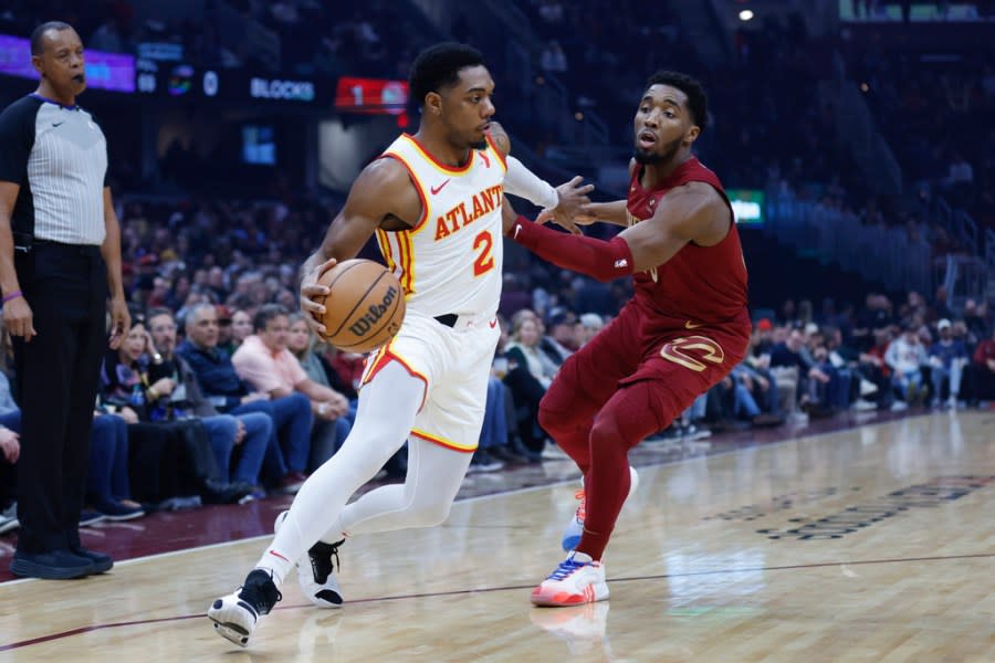 Atlanta Hawks guard Trent Forrest (2) drives against Cleveland Cavaliers guard Donovan Mitchell during the first half of an NBA basketball game Saturday, Dec. 16, 2023, in Cleveland. (AP Photo/Ron Schwane)