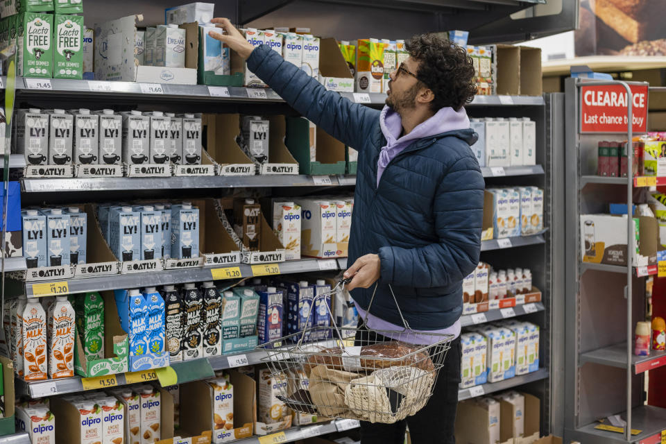 Man shopping in a supermarket while on a budget, UK.