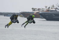 Jet suit pilots race in Dubai, United Arab Emirates, Wednesday, Feb. 28, 2024. Dubai on Wednesday hosted what it called its first-ever jet suit race. Racers zipped along a route with the skyscrapers of Dubai Marina looming behind them, controlling the jet engines on their hands and their backs. (AP Photo/Jon Gambrell)