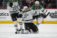 Dallas Stars center Matt Duchene, front, celebrates scoring the winning goal as defensemen Esa Lindell, back left, and Chris Tanev look on in the second overtime of Game 6 of an NHL hockey playoff series against the Colorado Avalanche Friday, May 17, 2024, in Denver. (AP Photo/David Zalubowski)