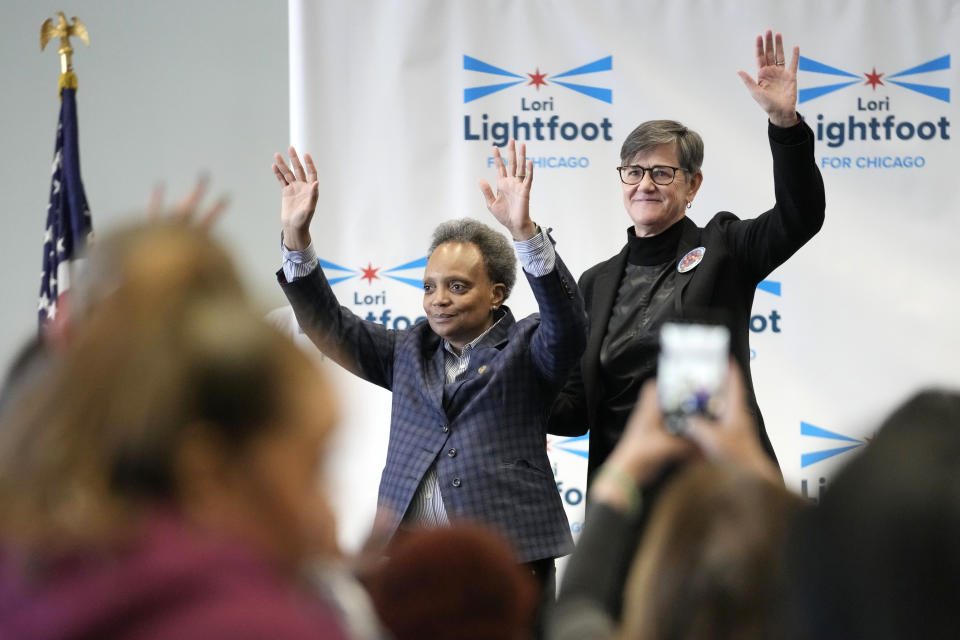 Chicago mayor Lori Lightfoot, left, and her spouse Amy Eshleman wave to supporters during Women for Lori Rally in Chicago, Saturday, Feb. 25, 2023. Lightfoot is fighting for reelection Tuesday after a history-making but tumultuous four years in office and a bruising campaign threaten to make her the city's first one-term mayor in decades. (AP Photo/Nam Y. Huh)