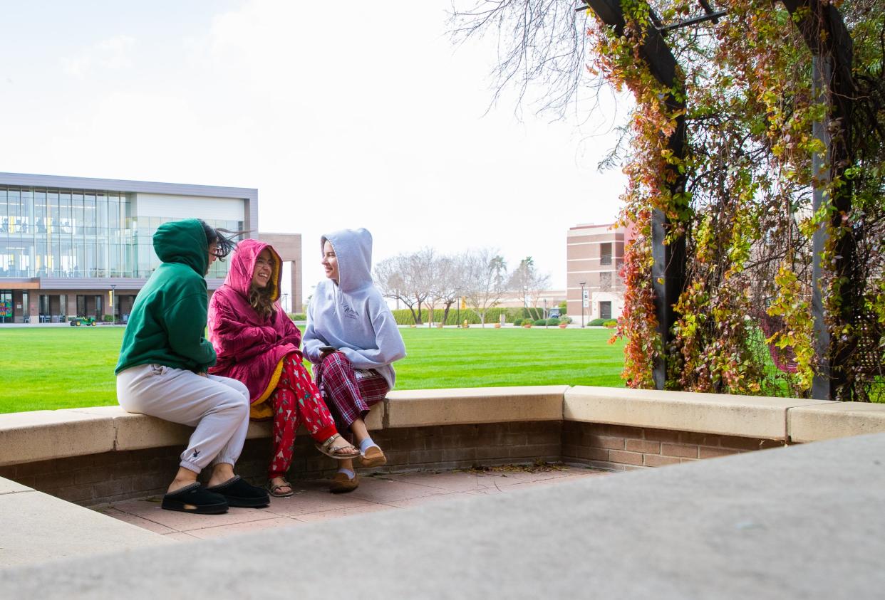 A group of first-year ASU students sits on a bench at the West ASU Campus in Glendale on Feb. 22, 2023.