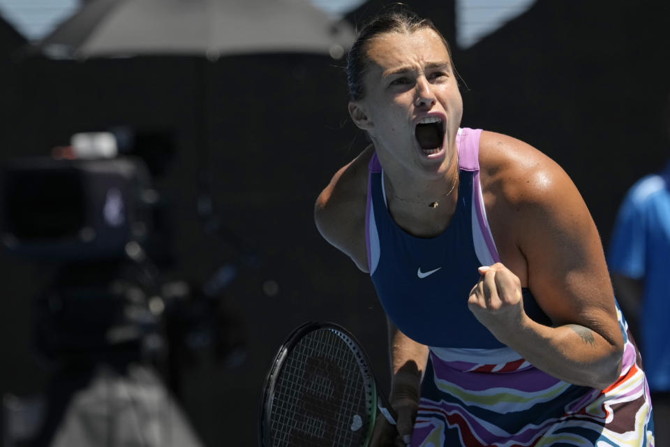 Aryna Sabalenka of Belarus celebrates after defeating Belinda Bencic of Switzerland in their fourth round match at the Australian Open tennis championship in Melbourne, Australia, Monday, Jan. 23, 2023. (AP Photo/Aaron Favila)