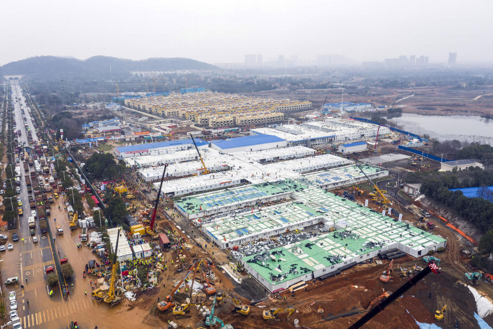 The Huoshenshan temporary field hospital under construction is seen as it nears completion in Wuhan in central China's Hubei Province, Sunday, Feb. 2, 2020. The Philippines on Sunday reported the first death from a new virus outside of China, where authorities delayed the opening of schools in the worst-hit province and tightened quarantine measures in a city that allow only one family member to venture out to buy supplies. (Chinatopix via AP)