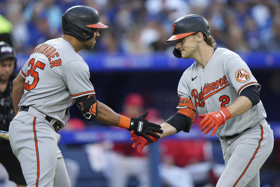 Baltimore Orioles' Gunnar Henderson (2) celebrates after his solo home run with teammate Anthony Santander (25) during third-inning baseball game action against the Toronto Blue Jays in Toronto, Monday, July 31, 2023. (Nathan Denette/The Canadian Press via AP)