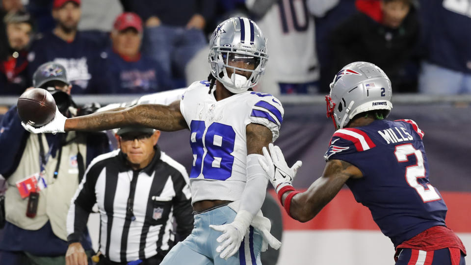 Dallas Cowboys wide receiver CeeDee Lamb (88) stretches the ball over the goal line for the game-winning touchdown, as New England Patriots cornerback Jalen Mills (2) gives chase, during overtime of an NFL football game, Sunday, Oct. 17, 2021, in Foxborough, Mass. (AP Photo/Michael Dwyer)