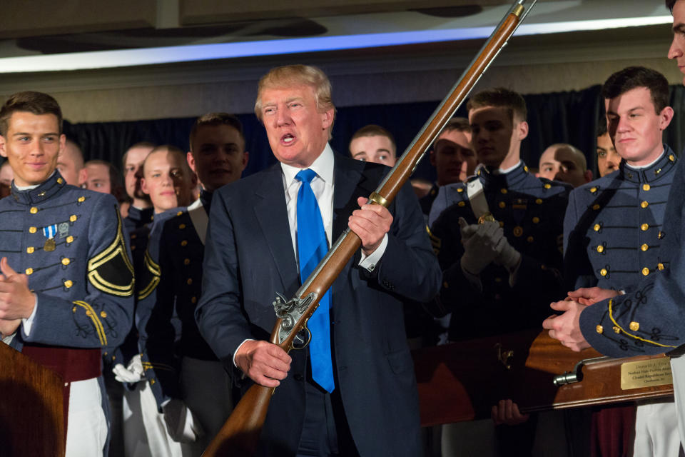 Donald Trump holds a replica flintlock rifle given to him by cadets during the Republican Society Patriot Dinner at the Citadel, the Military College of South Carolina, on Feb. 22, 2015, in Charleston, S.C. Trump and Sen. Tim Scott, R-S.C., were honored at the annual event. (Photo by Richard Ellis/Getty Images)