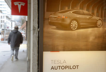An advertisement promotes Tesla Autopilot at a showroom of U.S. car manufacturer Tesla in Zurich, Switzerland March 28, 2018. REUTERS/Arnd Wiegmann/Files