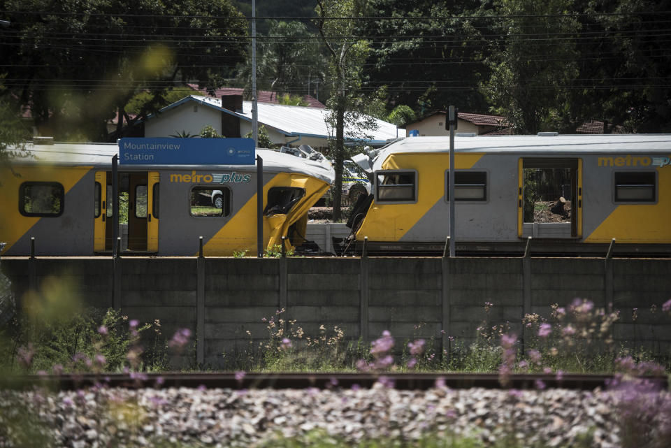 Train carriages are damaged after a train collision at the Mountainview station in Pretoria, South Africa, Tuesday, Jan. 8, 2019. Authorities say that the accident in the capital has killed three people and injured more than 200. (AP Photo)