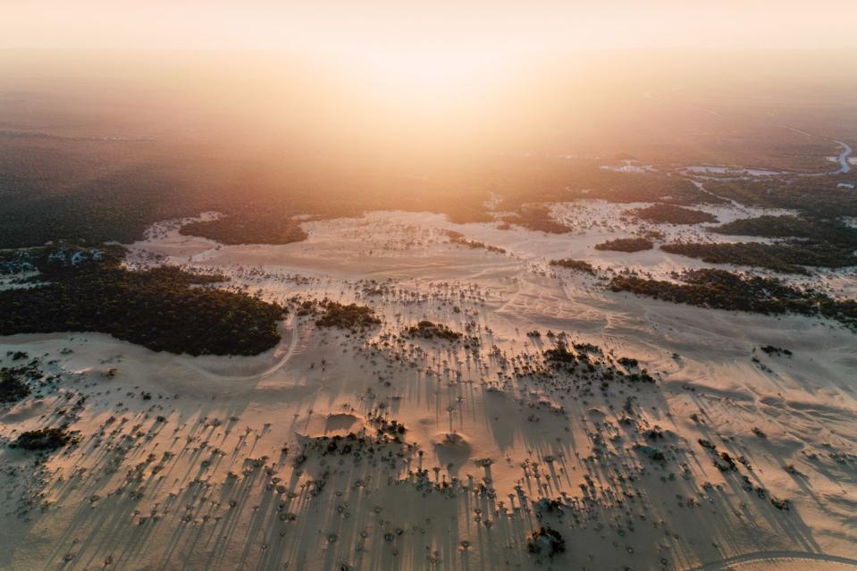 <p>The sun sets on the white, sandy plane of The Pinnacles in Western Australia.</p>