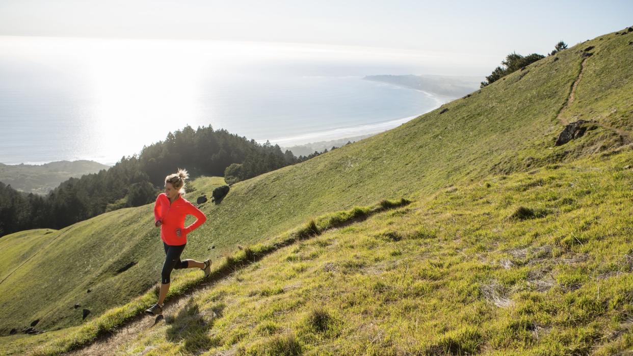  woman running in hills 