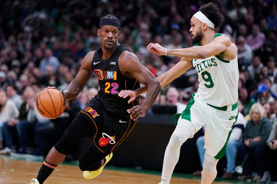 Miami Heat forward Jimmy Butler (22) drives to the basket against Boston Celtics guard Derrick White (9) during the second half of an NBA basketball game Wednesday, March 30, 2022, in Boston. (AP Photo/Charles Krupa)