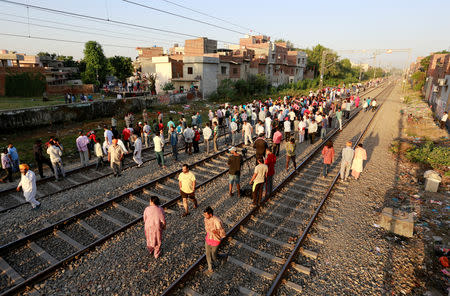 People gather at the site of an accident after a commuter train traveling at high speed ran through a crowd of people on the rail tracks on Friday, in Amritsar, India, October 20, 2018. REUTERS/Adnan Abidi