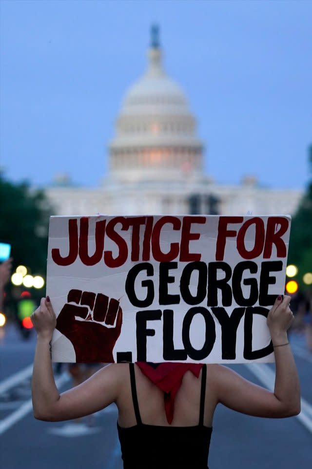 Demonstrators walk along Pennsylvania Avenue as they protest the death of George Floyd 