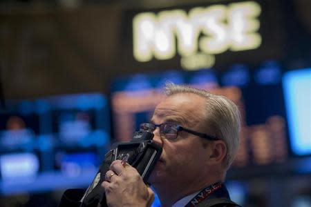 A trader looks up at a screen on the floor of the New York Stock Exchange May 1, 2014. REUTERS/Brendan McDermid