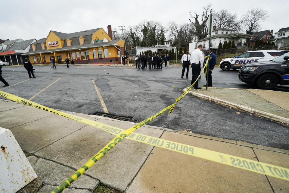 FILE - Police tape is seen at the site of a shooting near Edmondson Westside High School, Jan. 4, 2023, in Baltimore. In response to rising youth violence, Baltimore leaders are ramping up efforts to de-escalate conflicts between young people and protect students going to and from school. (AP Photo/Julio Cortez, file)