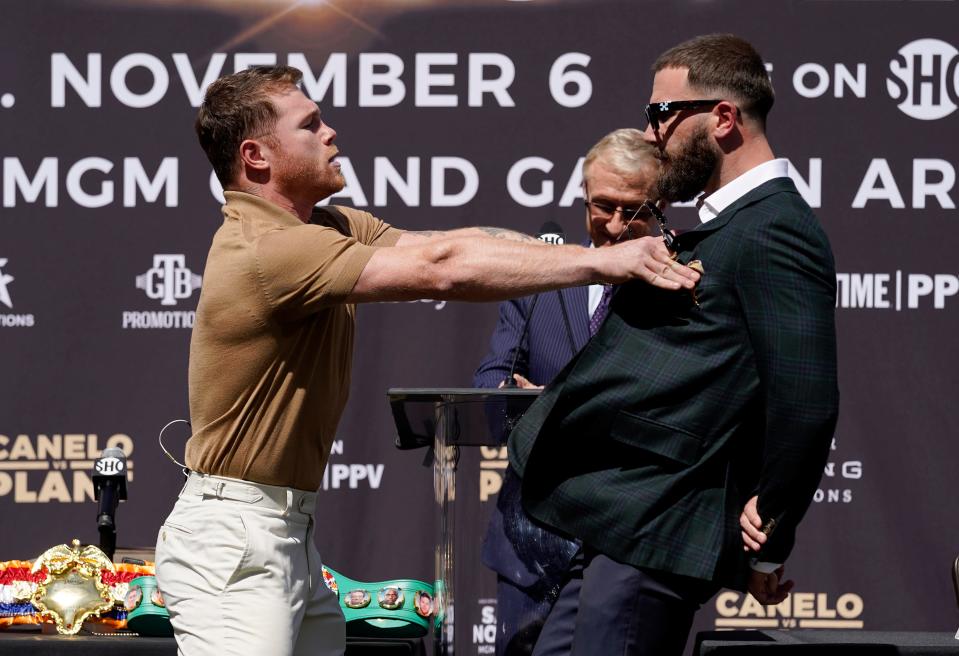 Canelo Alvarez, left, shoves Caleb Plant during a news conference Tuesday in Beverly Hills to announce their 168-pound title bout on Nov. 6.