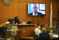 A TV still frame of Robert Durst appears on a screen in the courtroom as Deputy District Attorney John Lewin begins opening statements in trial of Durst, a real estate scion charged with murder of his longtime friend Susan Berman, in Los Angeles County Superior Court, Tuesday, May 18, 2021, in Inglewood, Calif. Durst has pleaded not guilty to killing his best friend, Berman, in 2000 at her Los Angeles home. Durst's murder trial was delayed more than a year due to the Covid-19 pandemic. (Al Seib/Los Angeles Times via AP, Pool)