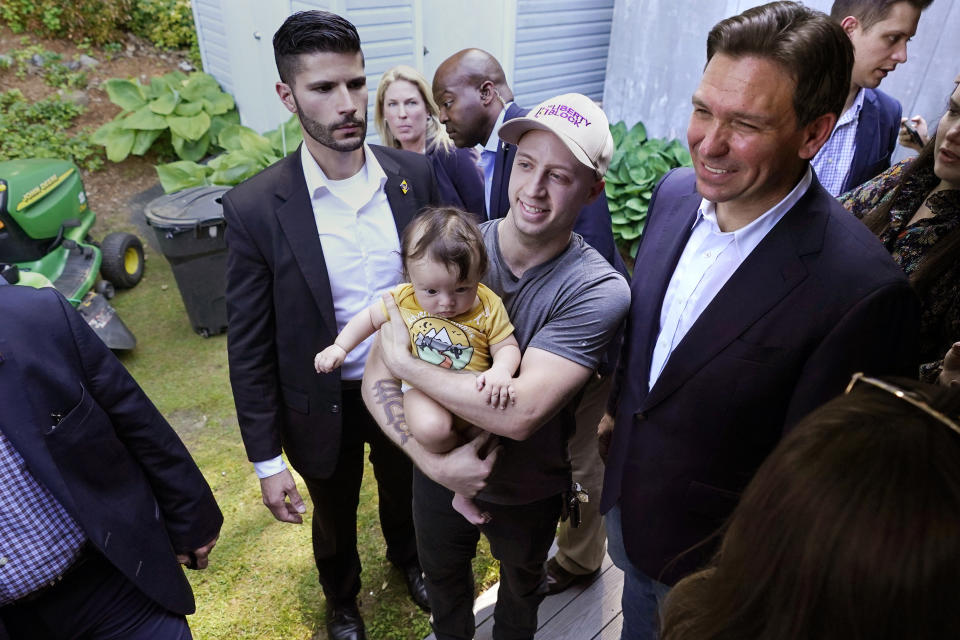 Republican presidential candidate Florida Gov. Ron DeSantis poses with guests during a campaign event, Thursday, June 1, 2023, in Salem, N.H. (AP Photo/Charles Krupa)