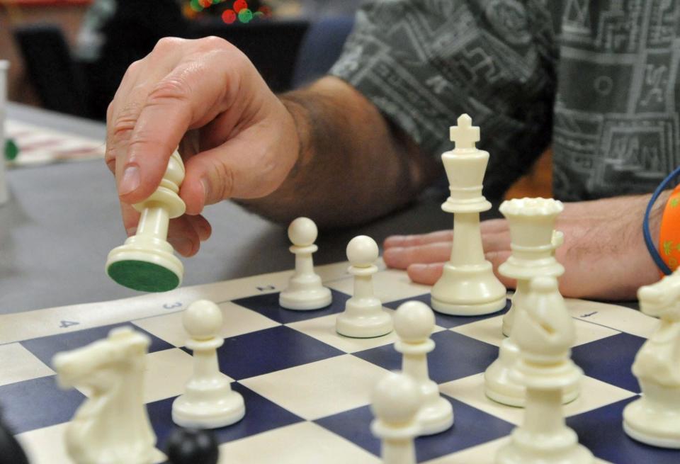 Michael Yezukevich, of Quincy, founder of the Quincy Chess Club, moves his bishop during the club's first night at Bethany Congregational Church in Quincy on Wednesday, Jan. 3, 2024.