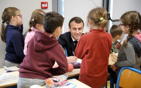 French President Emmanuel Macron visits a school in Saint-Sozy, southwestern France - Credit: &nbsp;REUTERS