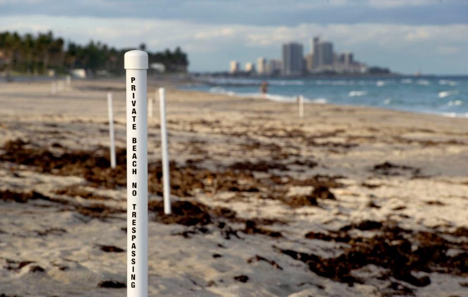The Town Council is holding a public meeting Monday to address beach access and public use of the eight-block stretch between Sunset Avenue and Wells Road. As of December 3, plastic posts at the erosion control line are in place to advise where beachgoers can be cited for trespassing. MEGHAN MCCARTHY / THE PALM BEACH POST