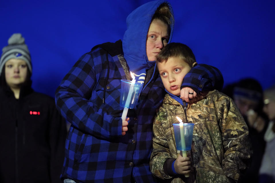 Local residents pray during a candlelight vigil following a shooting at Perry High School, Thursday, Jan. 4, 2024, in Perry, Iowa. (AP Photo/Charlie Neibergall)