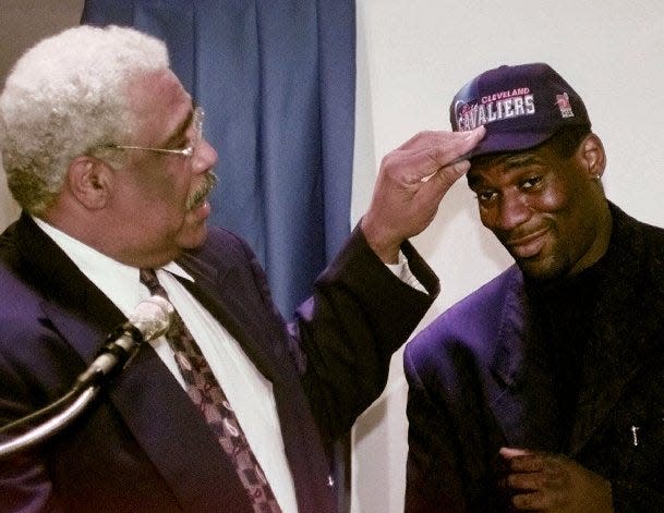 Cleveland Cavaliers general manager Wayne Embry, left, places a team cap on Shawn Kemp's head during a news conference Friday, Sept. 26, 1997, in Cleveland. The Cavaliers obtained Kemp Thursday night in a three-way deal with Seattle and Milwaukee.