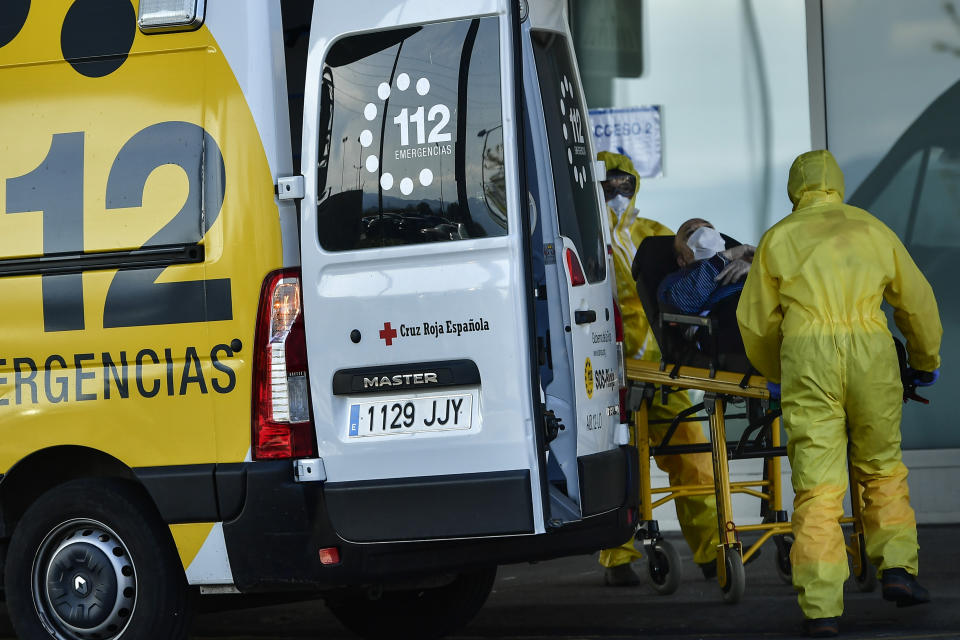 Staff health medical ambulances wearing special equipment to prevent the spread of coronavirus COVID-19 arriving with a patient at San Pedro hospital, in Logrono, northern Spain, Saturday, March 28, 2020. The new coronavirus causes mild or moderate symptoms for most people, but for some, especially older adults and people with existing health problems, it can cause more severe illness or death. AP Photo/Alvaro Barrientos)