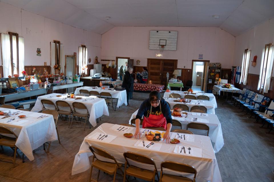 Dianne McMahon, 64, of Baraga, the chef at the annual Hunter's Stew in Herman, helps prepare the tables inside Herman Hall, in Michigan's Upper Peninsula, on Saturday, Nov. 18, 2023 in Herman.