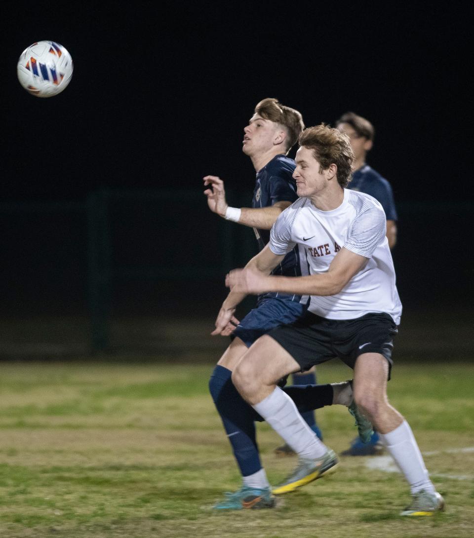 Gulf Breeze High's William Woodward (No. 11) battles Tate High's Michael Christenson (No. 11) for possession during the opening minutes of the District 1-6A Boys' Soccer finals on Wednesday, Feb. 1, 2023. 