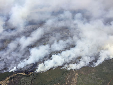 An aerial view from the helicopter of Alberta Premier Rachel Notley shows smoke rising from raging wildfires which caused the mandatory evacuation of Fort McMurray, Alberta, Canada May 4, 2016. Cheryl Oates/Government of Alberta/Handout via REUTERS