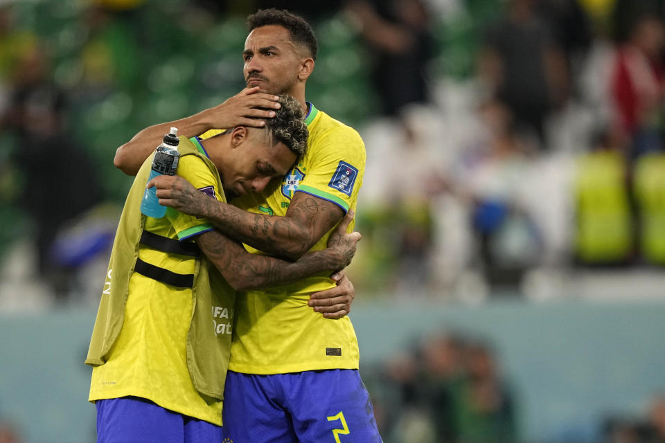 Brazil's Raphinha, left, and Brazil's Danilo react after the penalty shootout at the World Cup quarterfinal soccer match between Croatia and Brazil, at the Education City Stadium in Al Rayyan, Qatar, Friday, Dec. 9, 2022. (AP Photo/Martin Meissner)