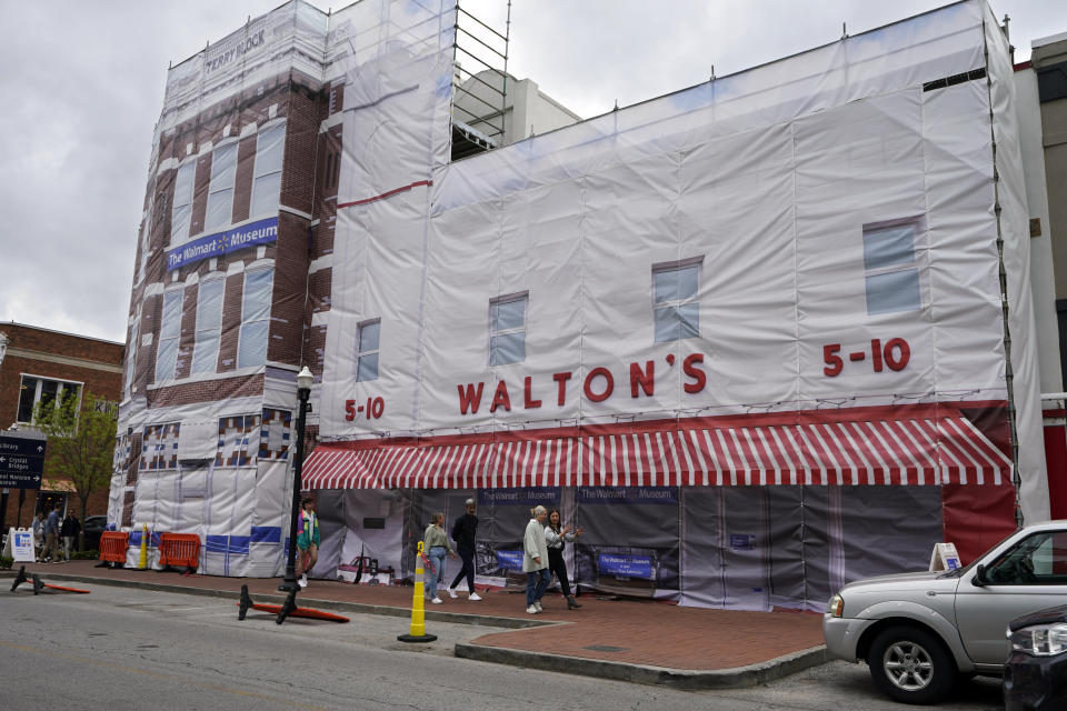 People walk past the original Walton's store on the Bentonville town square Wednesday, April 19, 2023, in Bentonville, Ark. The site normally houses the Walmart Museum. (AP Photo/Sue Ogrocki)