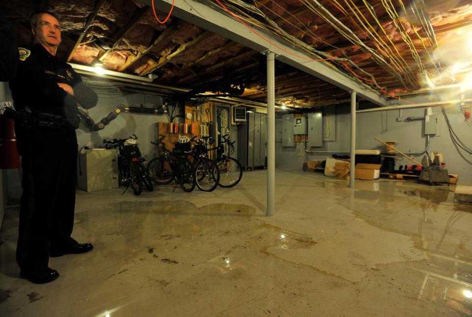 Rainwater flooded a portion of the old Sandwich Police Station in 2013 in the Route 6A area, a region included in a project aimed at mitigating the effects of climate change and sea-level rise.