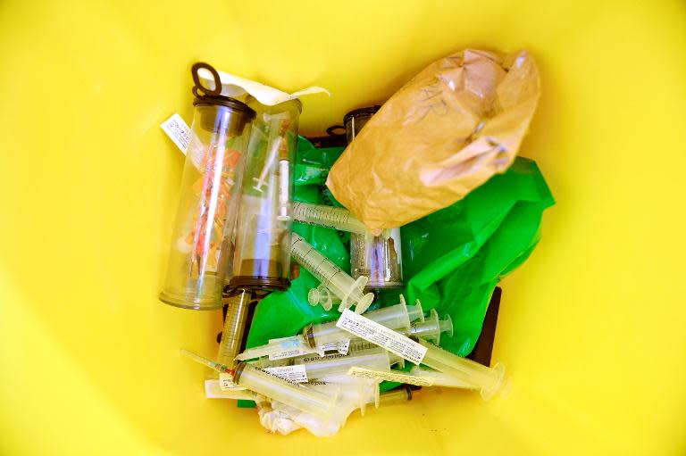 A trash containing used needles is seen at a needle exchange facility located at St Goeran's hospital in Stockholm, on April 2, 2014