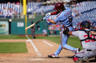 Philadelphia Phillies' Bryson Stott, left, hits a three RBI-double off Washington Nationals' Victor Arano during the eighth inning a baseball game, Sunday, Aug. 7, 2022, in Philadelphia. (AP Photo/Matt Rourke)