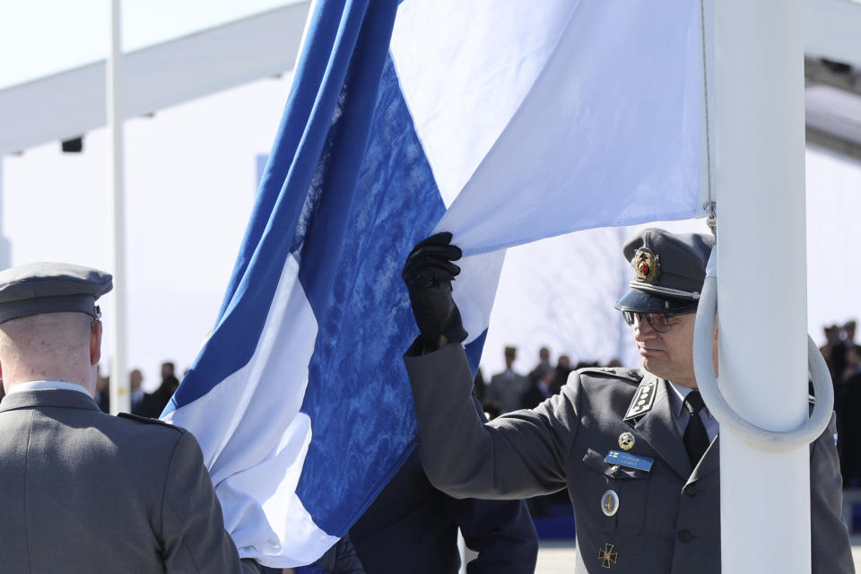 Military personnel prepare to raise the flag of Finland during a flag raising ceremony on the sidelines of a NATO foreign ministers meeting at NATO headquarters in Brussels, Tuesday, April 4, 2023. Finland joined the NATO military alliance on Tuesday, dealing a major blow to Russia with a historic realignment of the continent triggered by Moscow's invasion of Ukraine. (AP Photo/Geert Vanden Wijngaert)