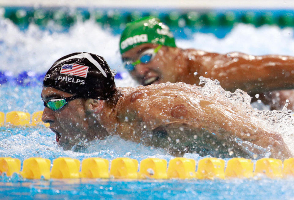 Chad Le Clos watches Michael Phelps beat him in the 200m Butterfly Semifinal.