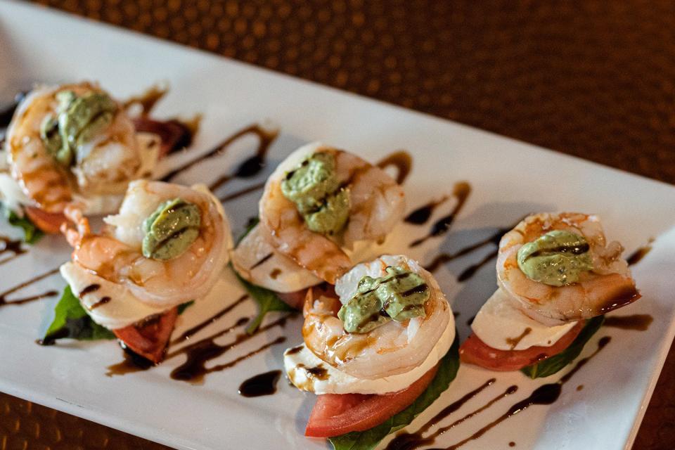 Fin & Flame Grill and Oyster Bar in Palm City features shrimp caprese.