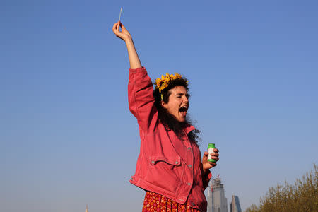 A climate change activist reacts during the Extinction Rebellion protest on Waterloo Bridge in London, Britain April 20, 2019. REUTERS/Simon Dawson