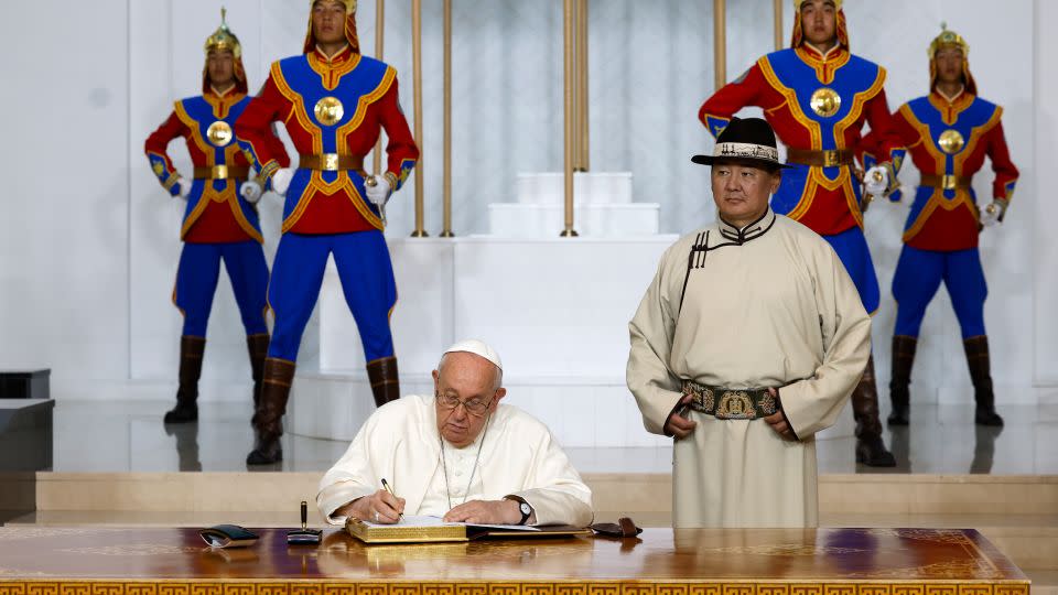 Mongolian President Ukhnaagin Khurelsukh signs the honor book alingside Pope Francis on Saturday.  - Remo Casilli/AP