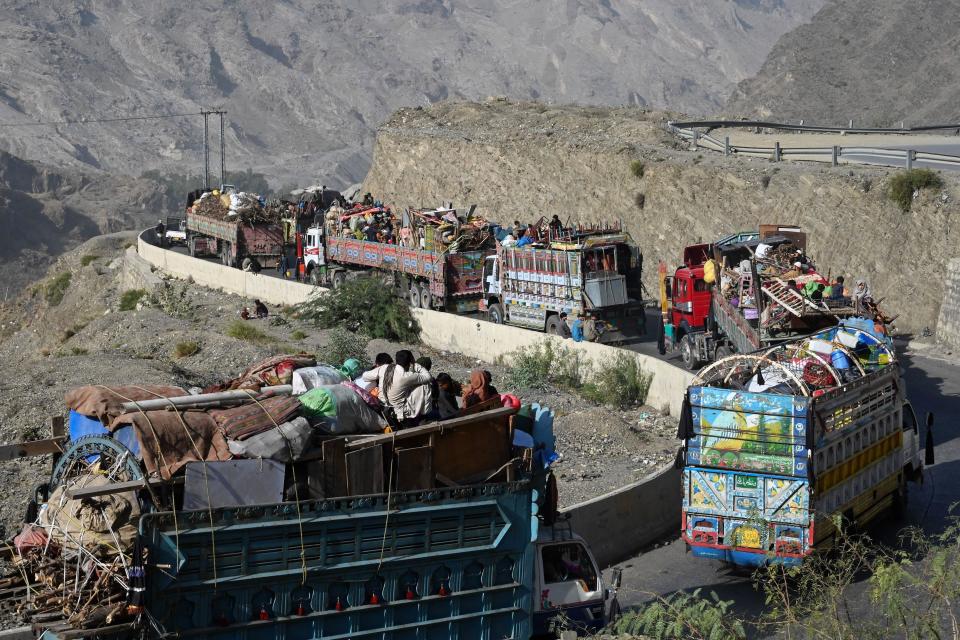 Trucks transporting Afghan refugees with their belongings are seen along a road towards the Pakistan-Afghanistan Torkham border on Nov. 3, 2023, following Pakistan's government decision to expel people illegally staying in the country.  / Credit: ABDUL MAJEED/AFP via Getty Images