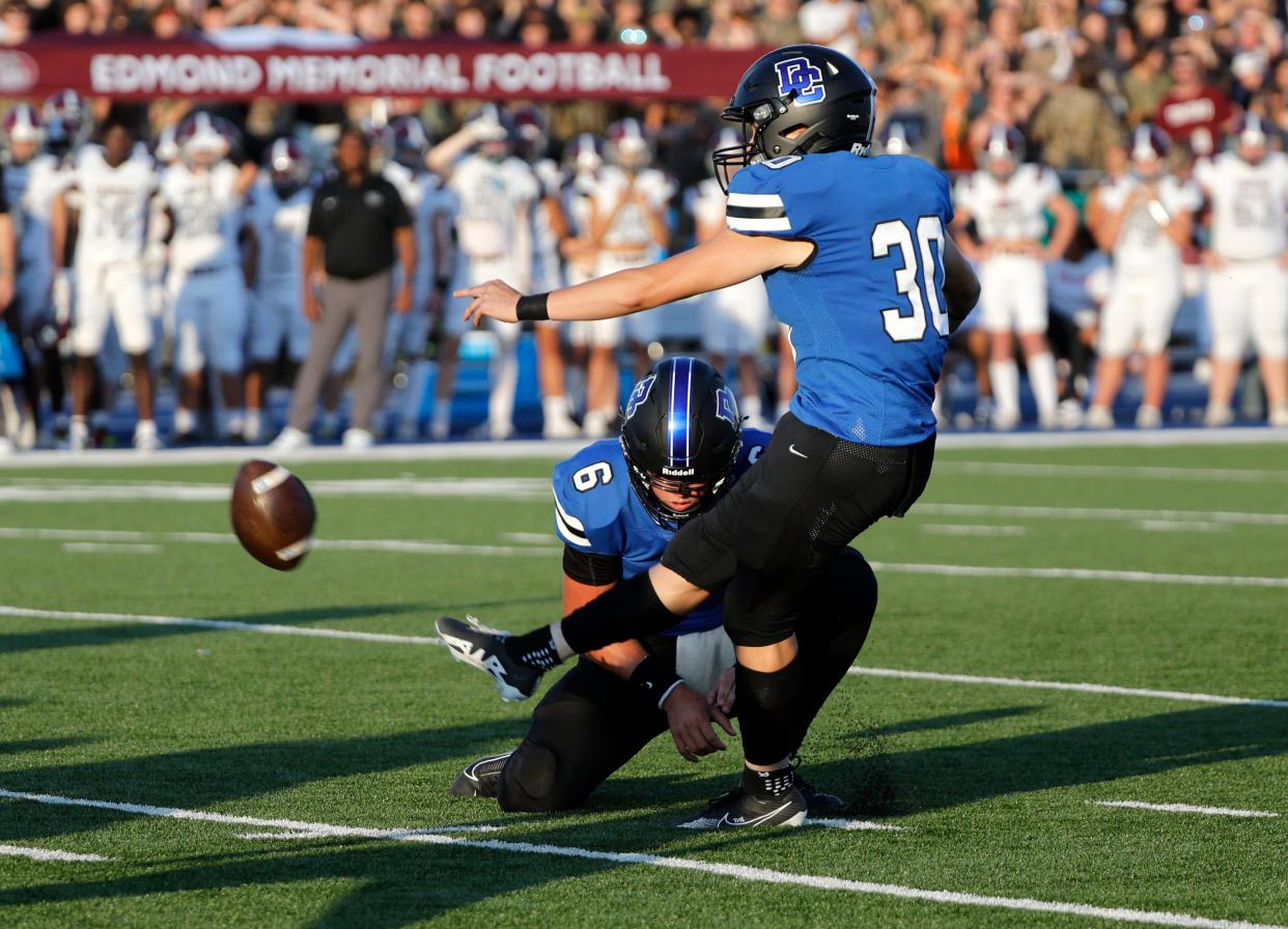 Deer Creek's Adrian Arambula kicks a field goal as Grady Adamson holds during the high school football game between Deer Creek and Edmond Memorial at Deer Creek High School, Friday, Sept., 1, 2023.