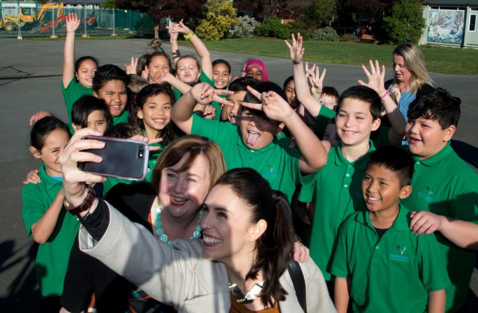 Ms Ardern grabs a selfie with students of Addington School in Christchurch, in 2017 (AP)