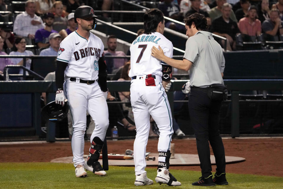 Arizona Diamondbacks first baseman Christian Walker (53) watches as Arizona Diamondbacks left fielder Corbin Carroll (7) is tended to for an injury during the seventh inning of the game against the New York Mets at Chase Field in Phoenix on July 6, 2023.