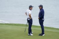 Team USA's Bryson DeChambeau talks to Phil Mickelson on the third hole during a practice day at the Ryder Cup at the Whistling Straits Golf Course Tuesday, Sept. 21, 2021, in Sheboygan, Wis. (AP Photo/Charlie Neibergall)