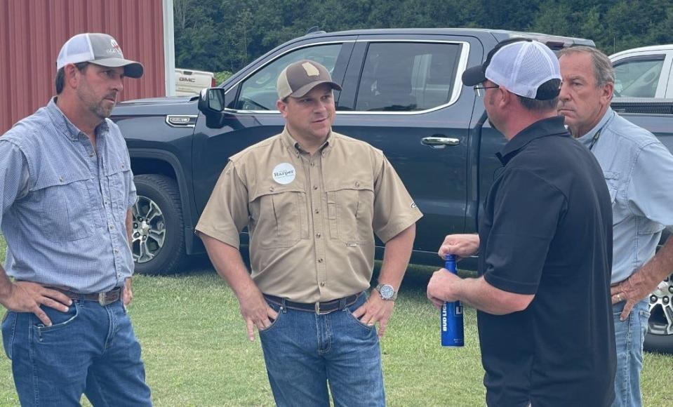 Agriculture Commissioner of Georgia Tyler Harper (center) talks with farmers in Jefferson County during his campaign.