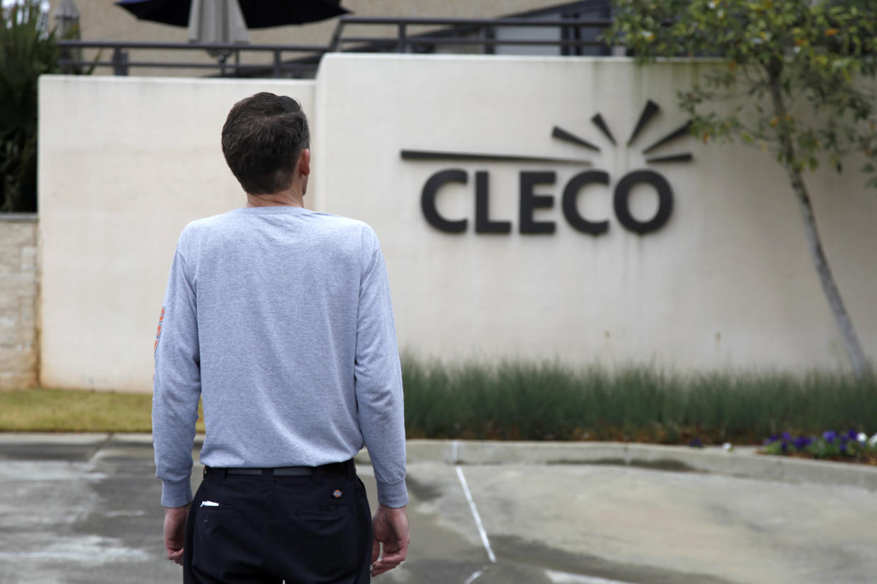 Chris Kinney, a resident of Rapides Parish in central Louisiana, who did not want his face seen, stands in front of the local Cleco Power office in Pineville, La., Thursday, Feb. 3, 2022. Kinney has had his electricity disconnected eight times in the past two years for falling behind on his energy bills and his family did everything to catch up: pawning items, accumulating vast overdraft fees, borrowing money and applying for energy assistance. Somehow, Kinney’s outstanding balance kept growing. (AP Photo/Jasen Lo)